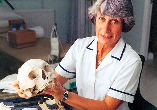 Myra Baston with skulls used for medical training